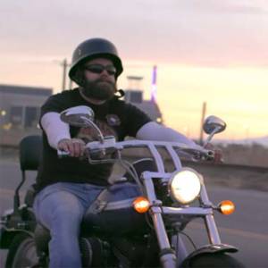 Man Wearing Liberate Headphones Riding Motorcycle